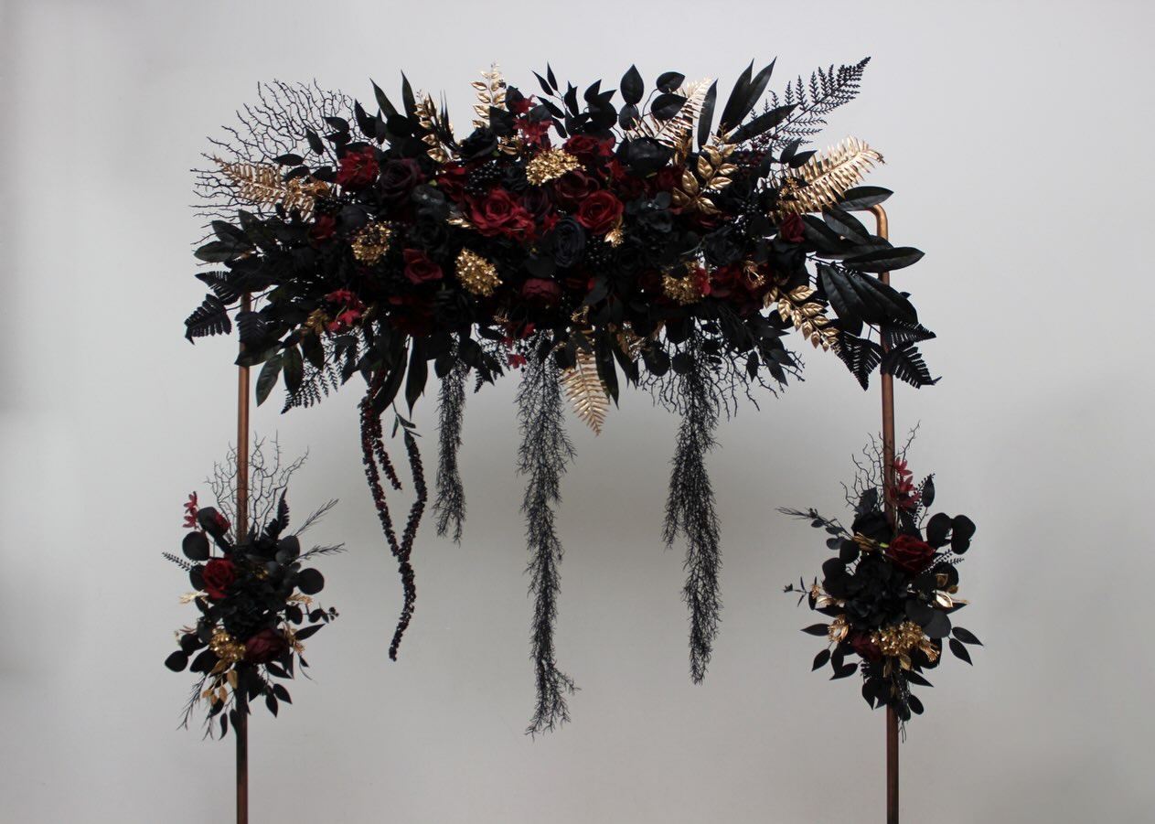 Black, Deep Burgundy & Metallic Gold — a bold and dramatic floral arch designed for a gothic glam or dark romance weddin