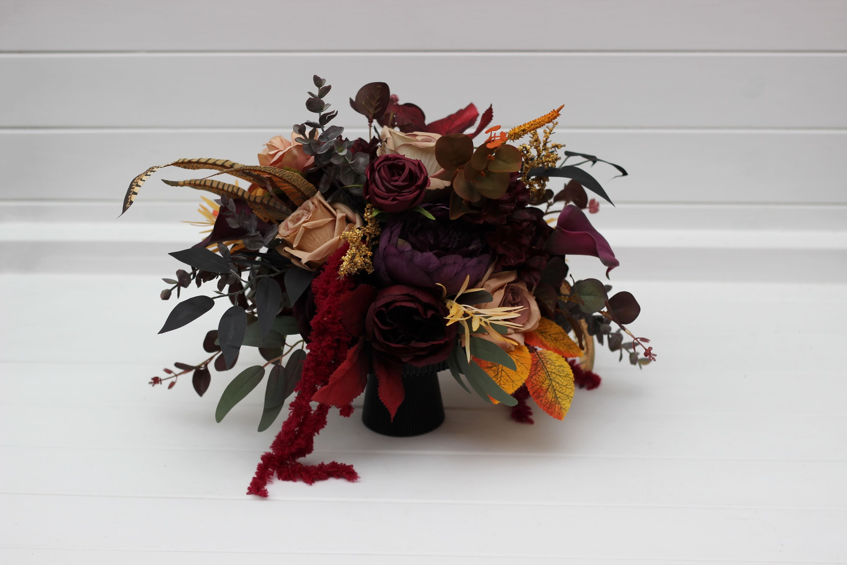 Deep Burgundy, Dark Plum & Warm Amber — a moody, autumn-inspired table centerpiece crafted with rich wine roses, dusty b