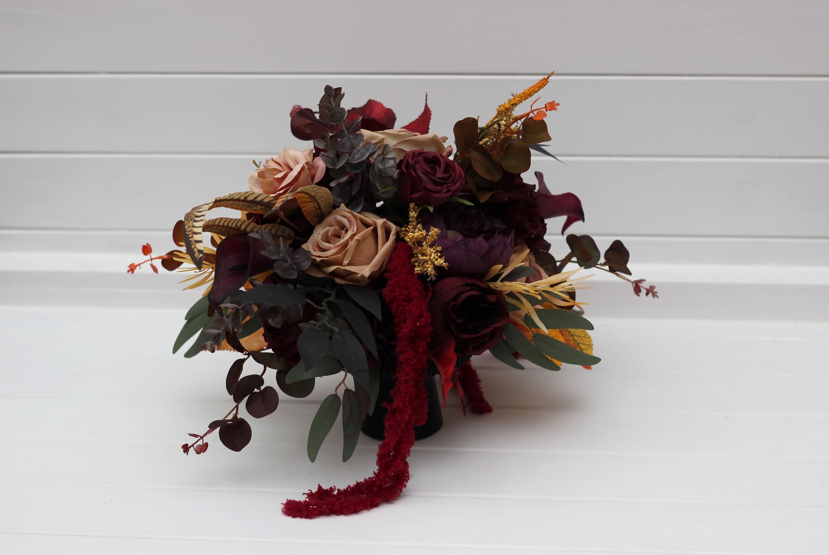 Deep Burgundy, Dark Plum & Warm Amber — a moody, autumn-inspired table centerpiece crafted with rich wine roses, dusty b