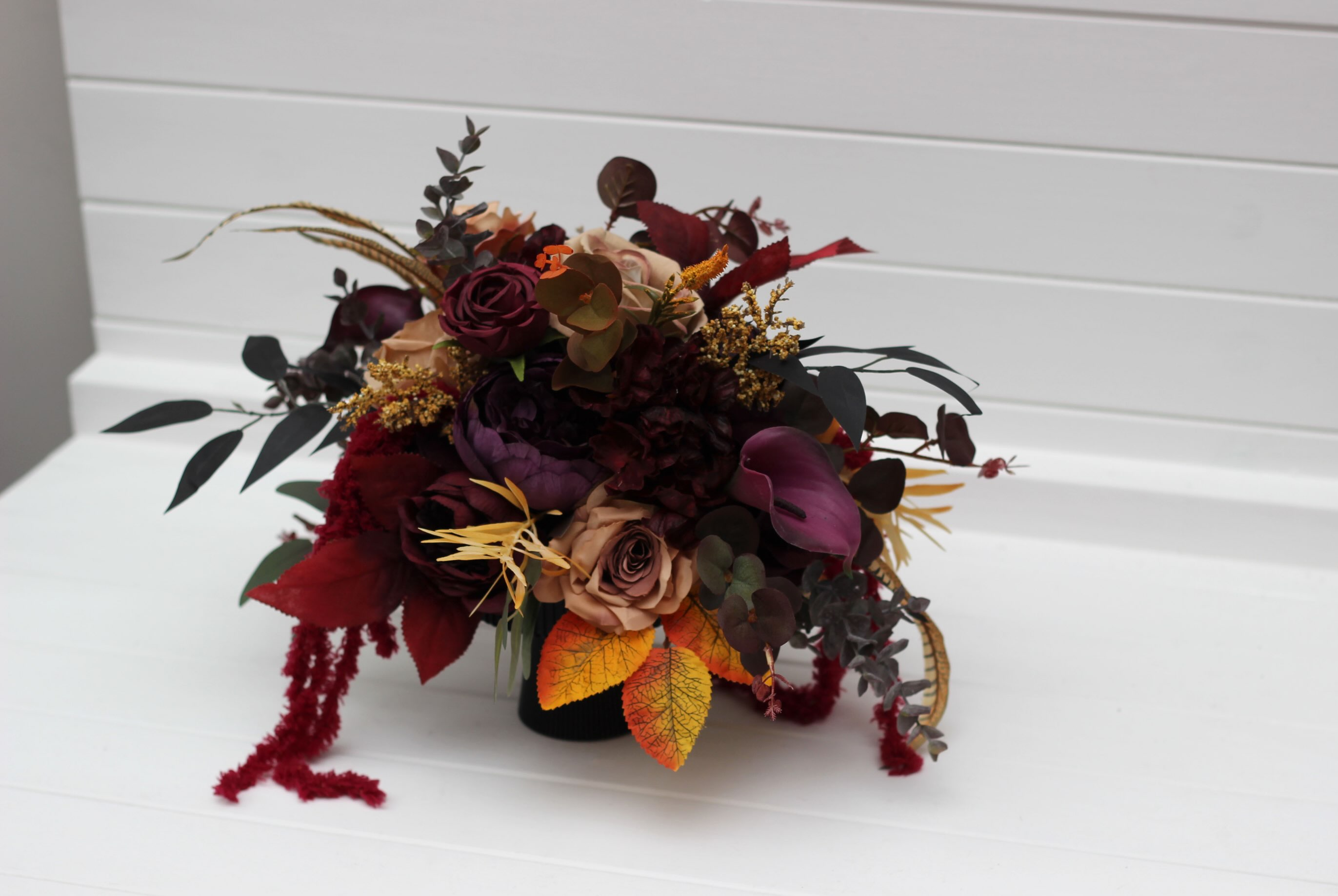 Deep Burgundy, Dark Plum & Warm Amber — a moody, autumn-inspired table centerpiece crafted with rich wine roses, dusty b