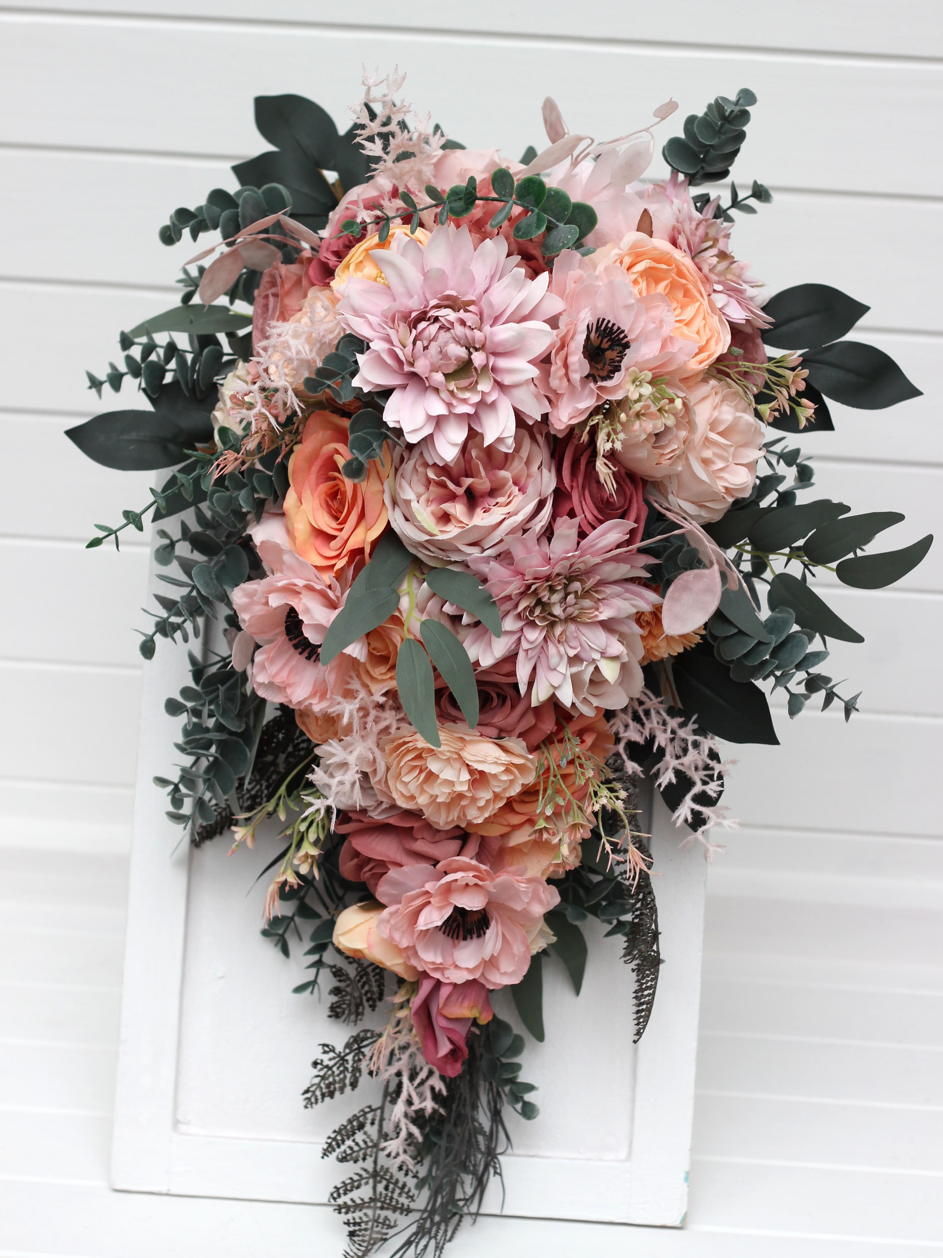 A timeless classic or a romantic cascading design? Both are created in a soft, dreamy palette of dusty pink, peach, blus