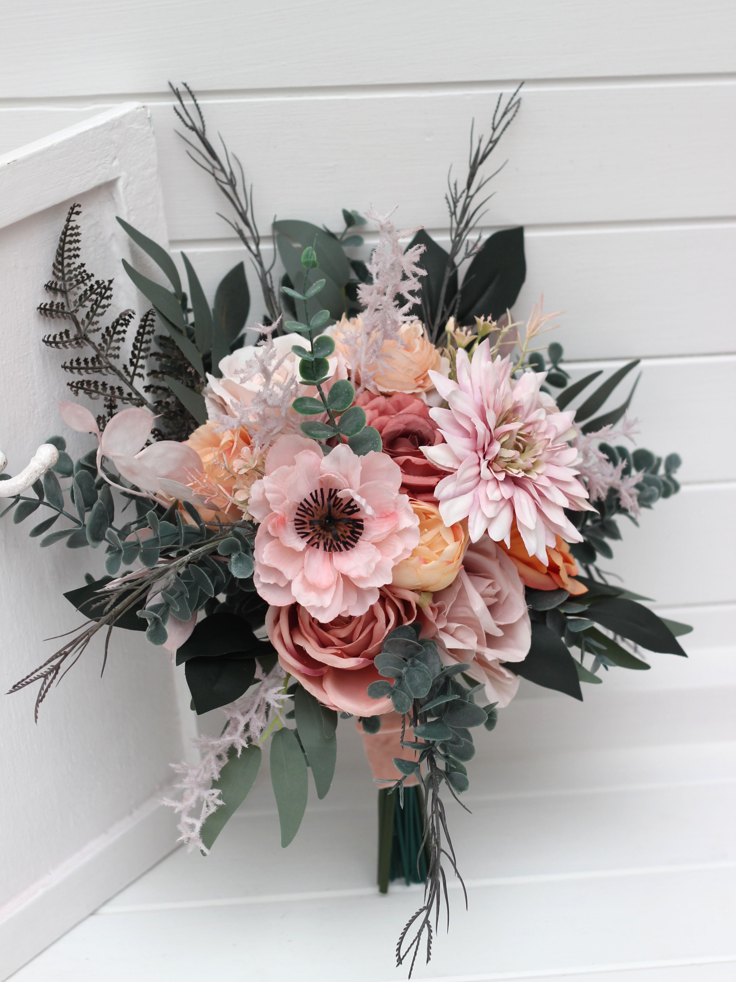 A timeless classic or a romantic cascading design? Both are created in a soft, dreamy palette of dusty pink, peach, blus