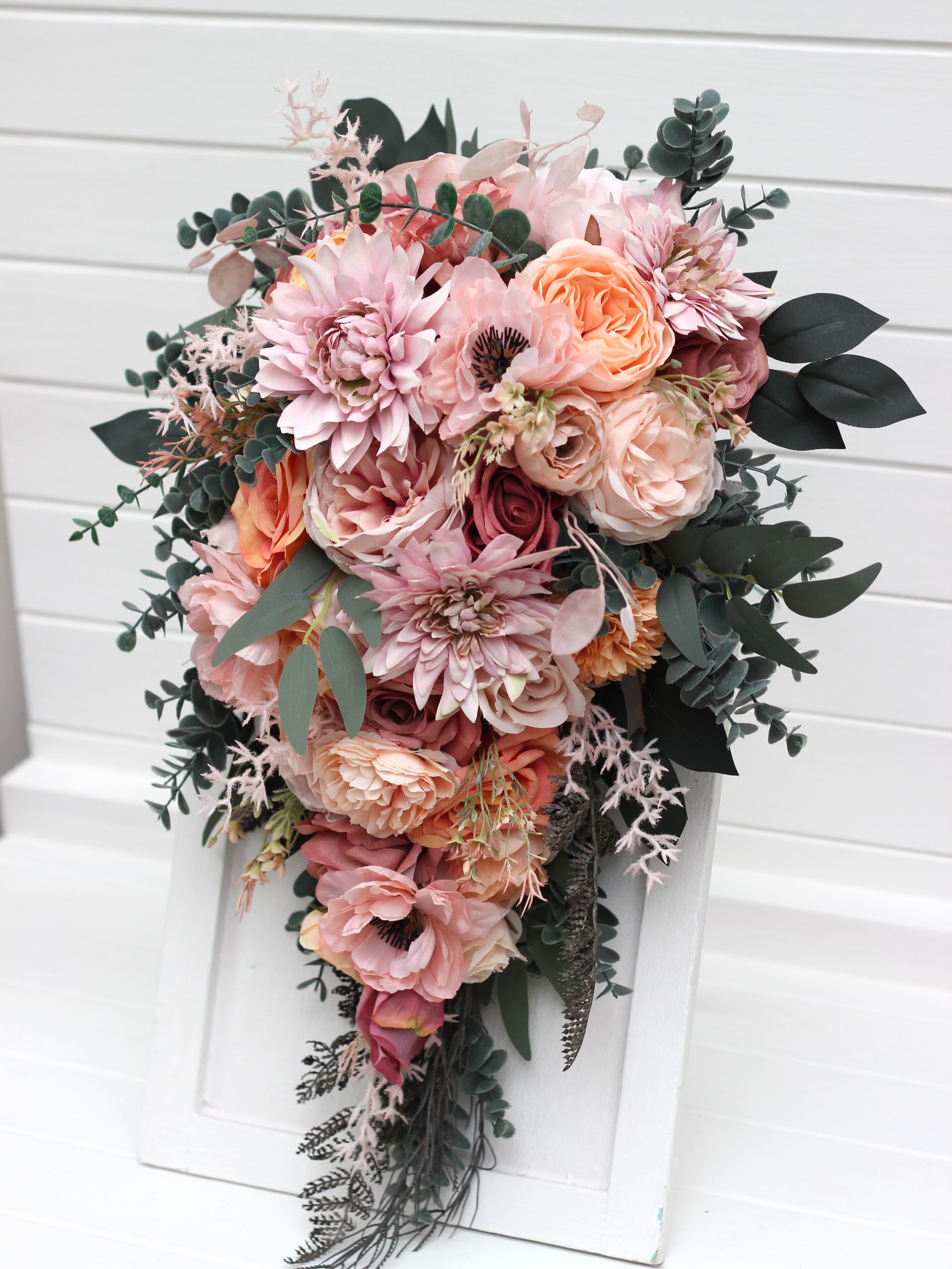 A timeless classic or a romantic cascading design? Both are created in a soft, dreamy palette of dusty pink, peach, blus