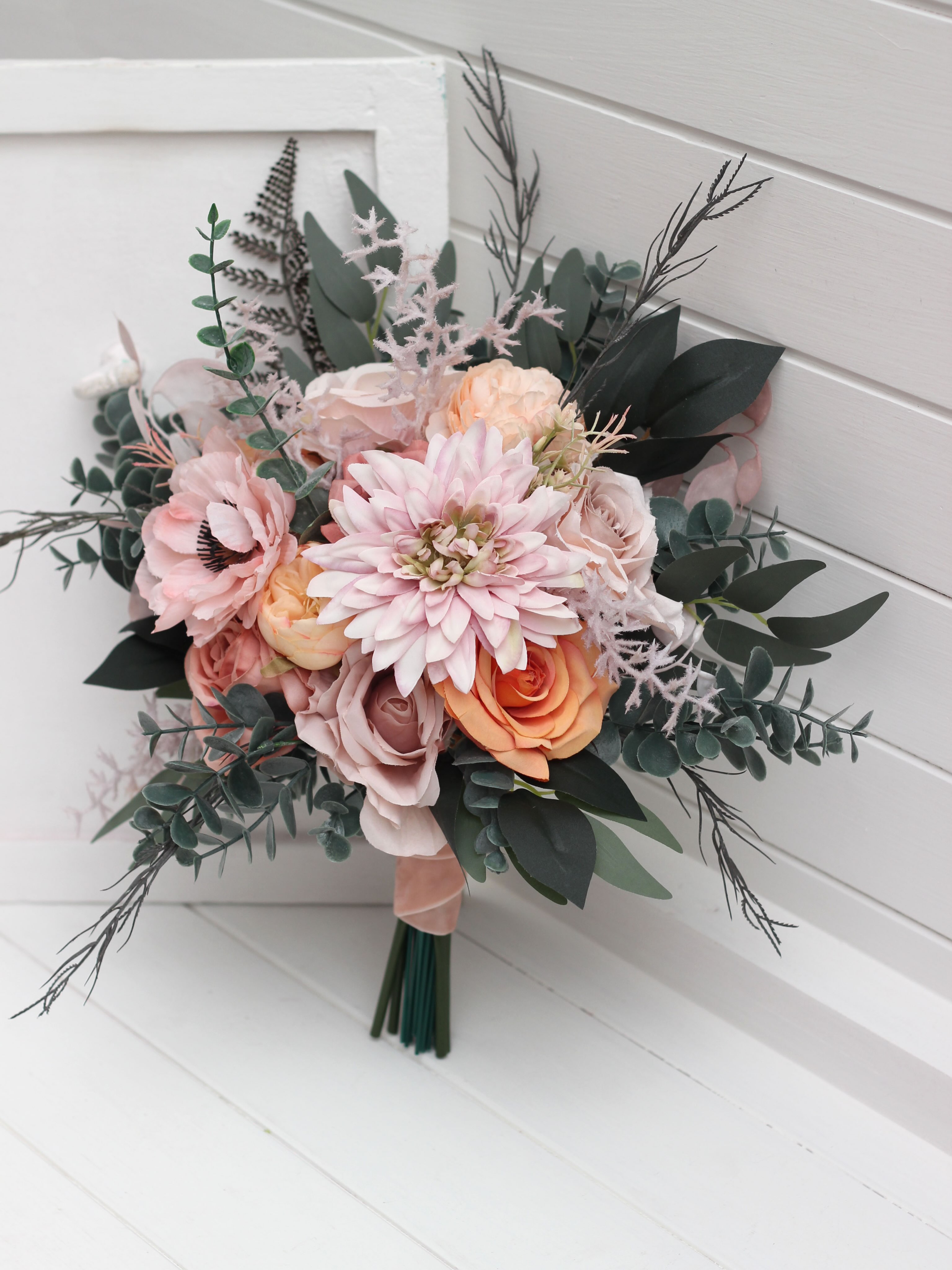 A timeless classic or a romantic cascading design? Both are created in a soft, dreamy palette of dusty pink, peach, blus