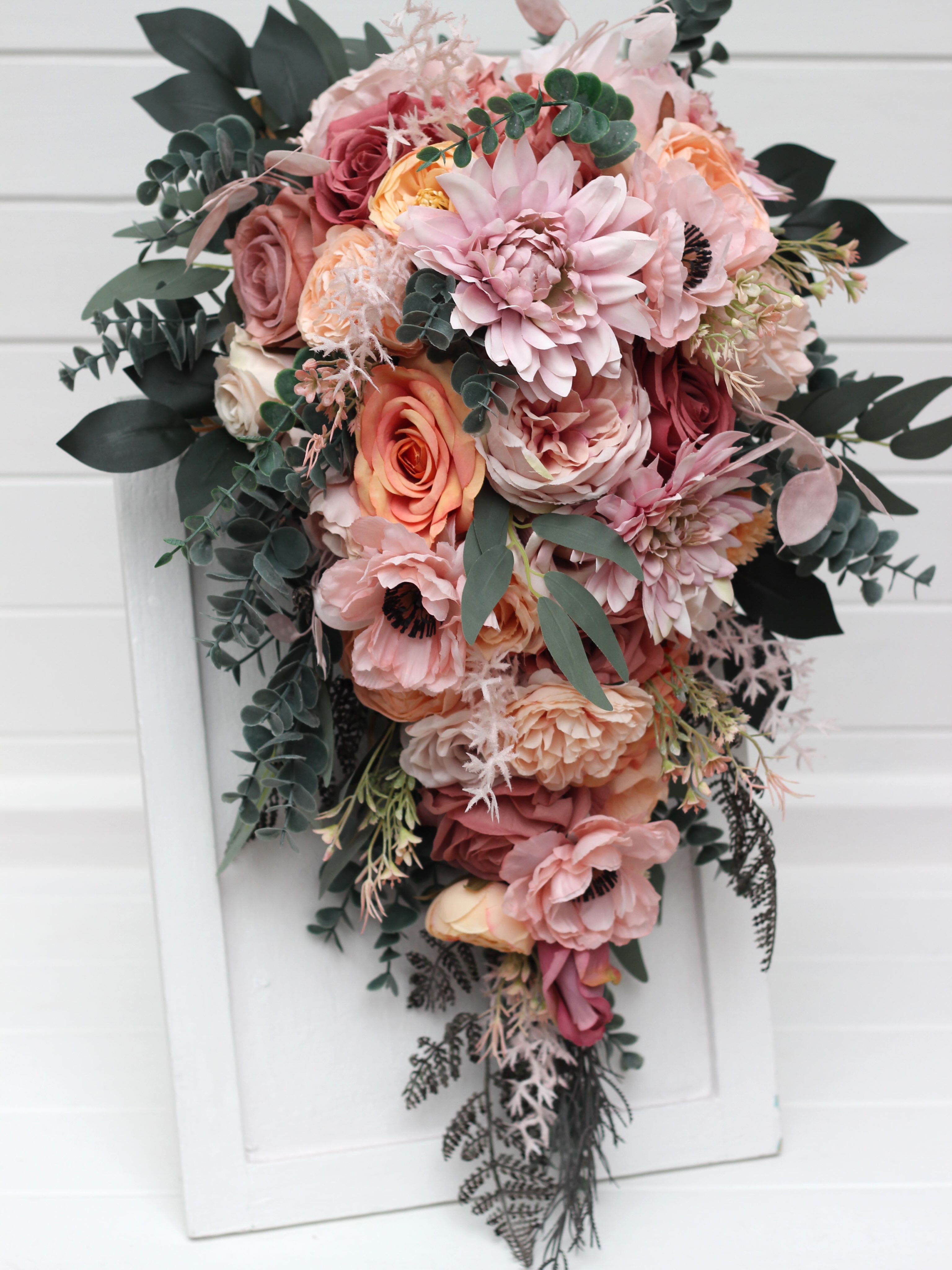 A timeless classic or a romantic cascading design? Both are created in a soft, dreamy palette of dusty pink, peach, blus