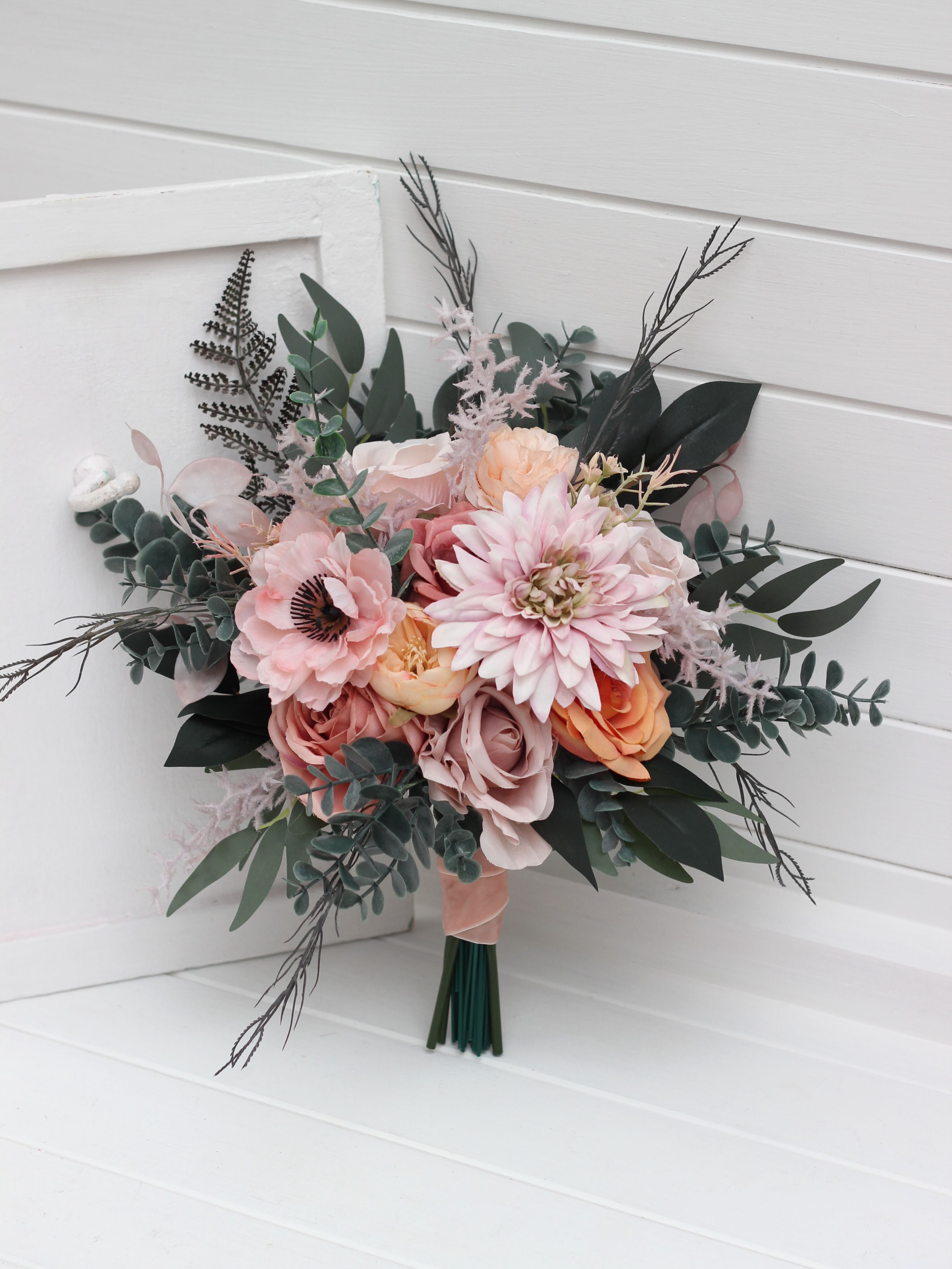 A timeless classic or a romantic cascading design? Both are created in a soft, dreamy palette of dusty pink, peach, blus