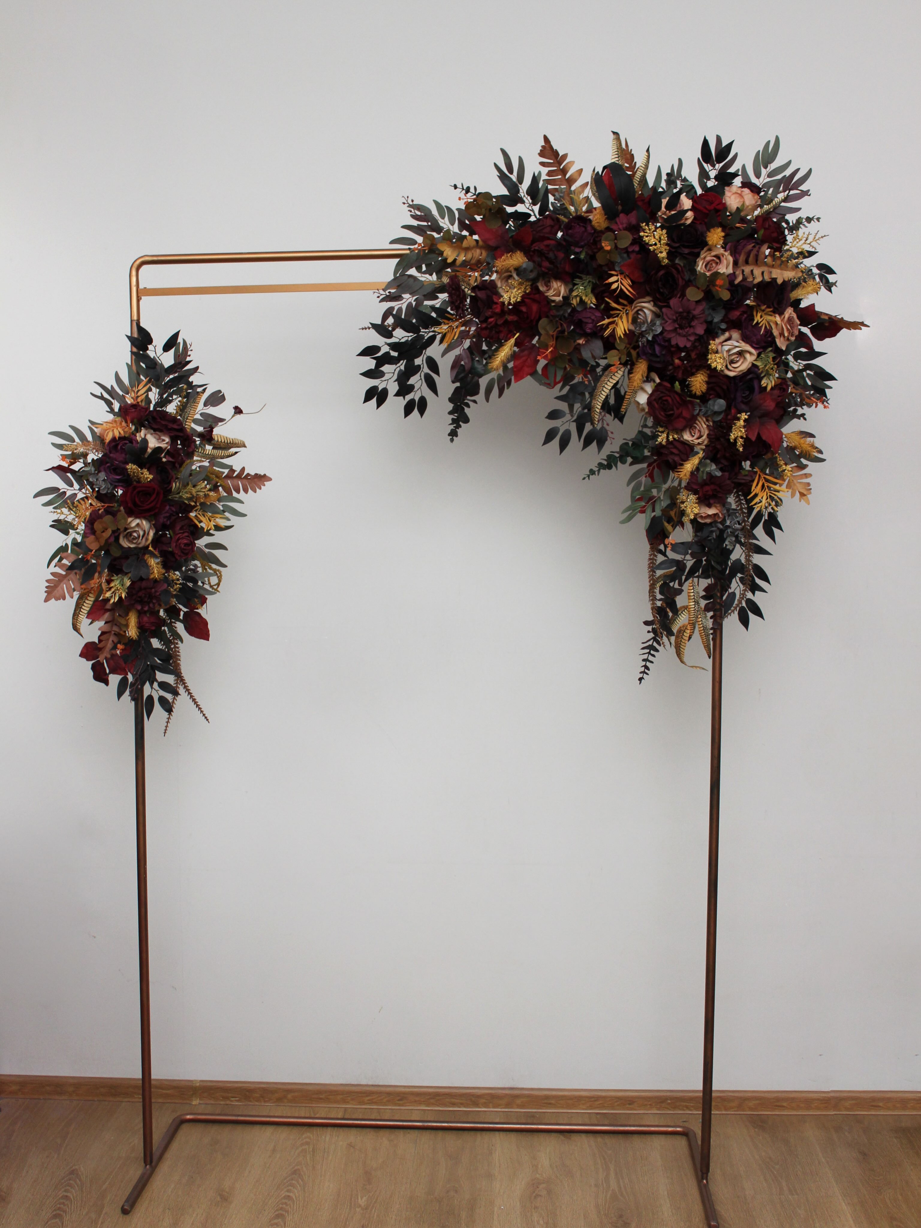 This flower arch on a sleek copper frame is the perfect statement piece for your special day. Deep burgundy roses, warm 
