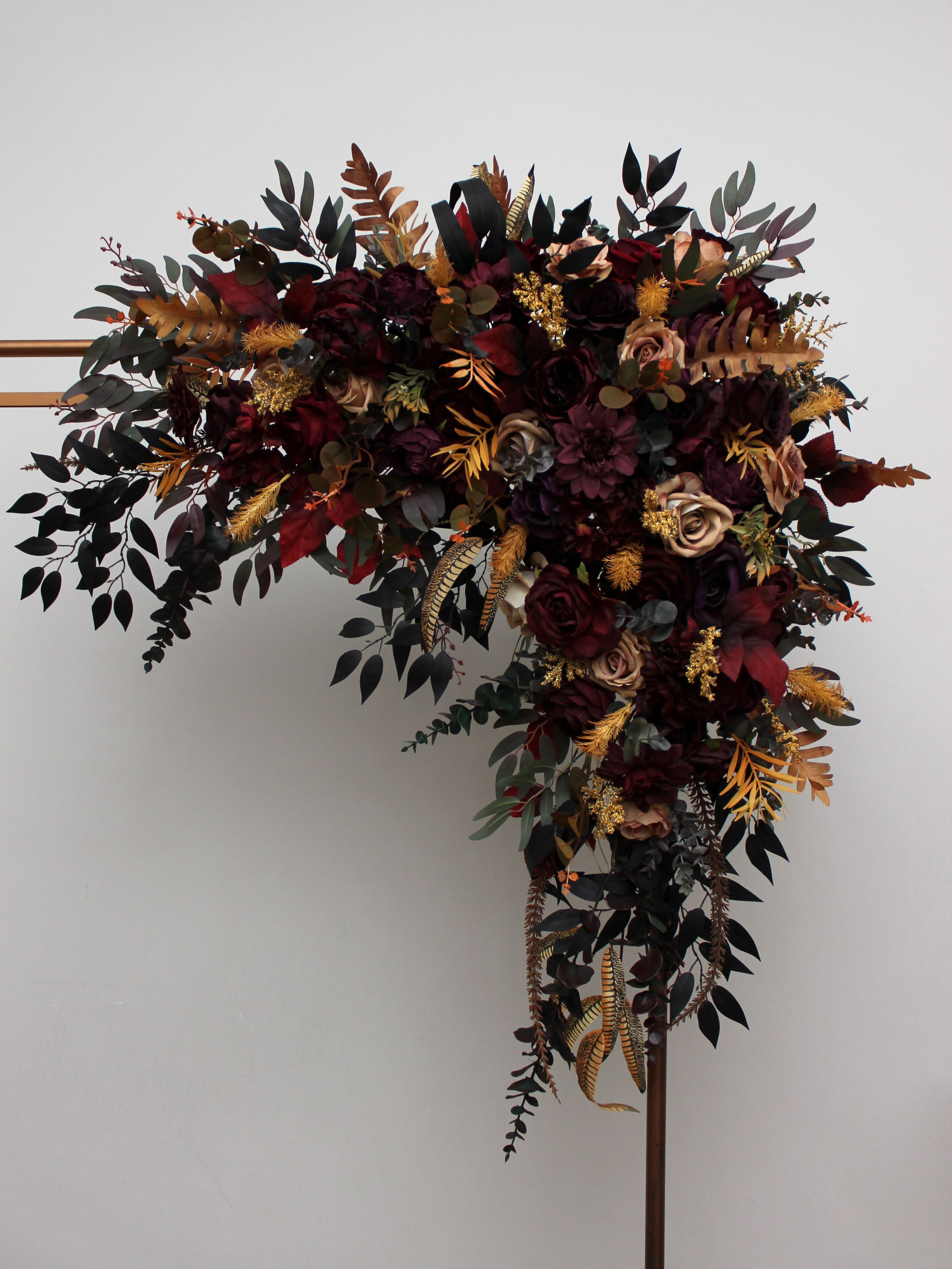 This flower arch on a sleek copper frame is the perfect statement piece for your special day. Deep burgundy roses, warm 